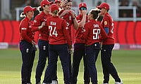 England's Emily Arlott celebrates with teammates after taking the wicket of West Indies' Aaliyah Alleyne