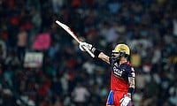 Royal Challengers Bengaluru's Virat Kohli celebrates reaching his half-century