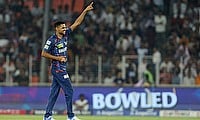 Lucknow Super Giants' Akash Singh celebrates after taking the wicket of Gujarat Titans' Jos Buttler playing for  Alembic Warriors