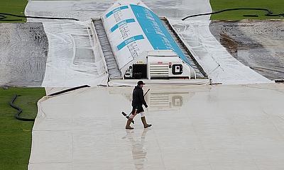 General view of the pitch covered as rain delays play