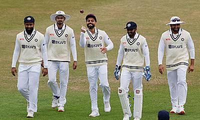 India's Virat Kohli walks out on the field with with teammates before the start